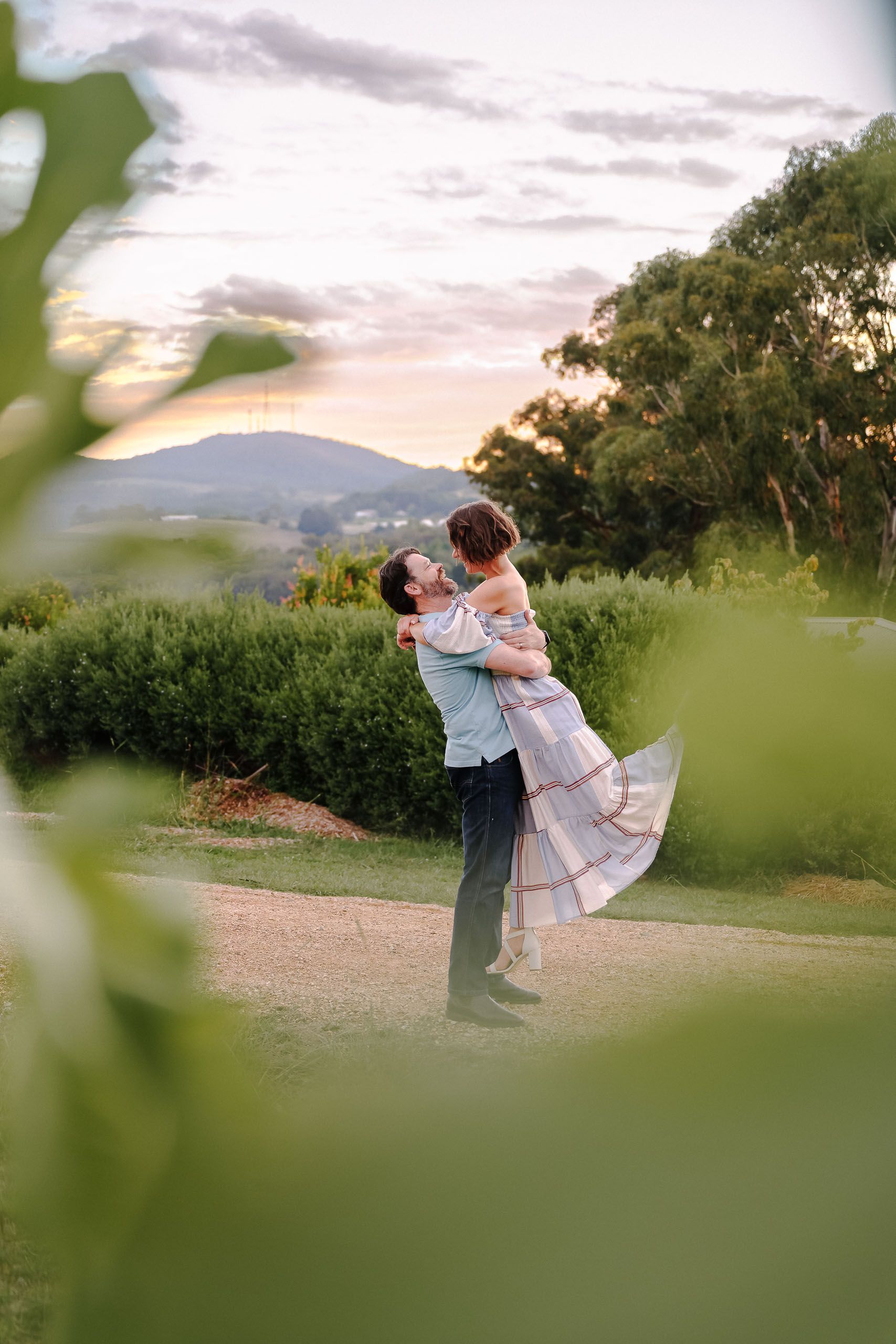 A Living Room With a Couch, Ottoman, and Table — Lakeview Luxury Retreat in Canobolas, NSW