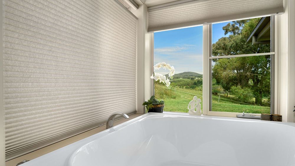 A Bathroom With a Bathtub and a Window With a View of a Field — Lakeview Luxury Retreat in Canobolas, NSW