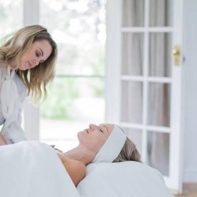 A Woman is Laying in a Bed With a Headband on Her Head — Lakeview Luxury Retreat in Canobolas, NSW