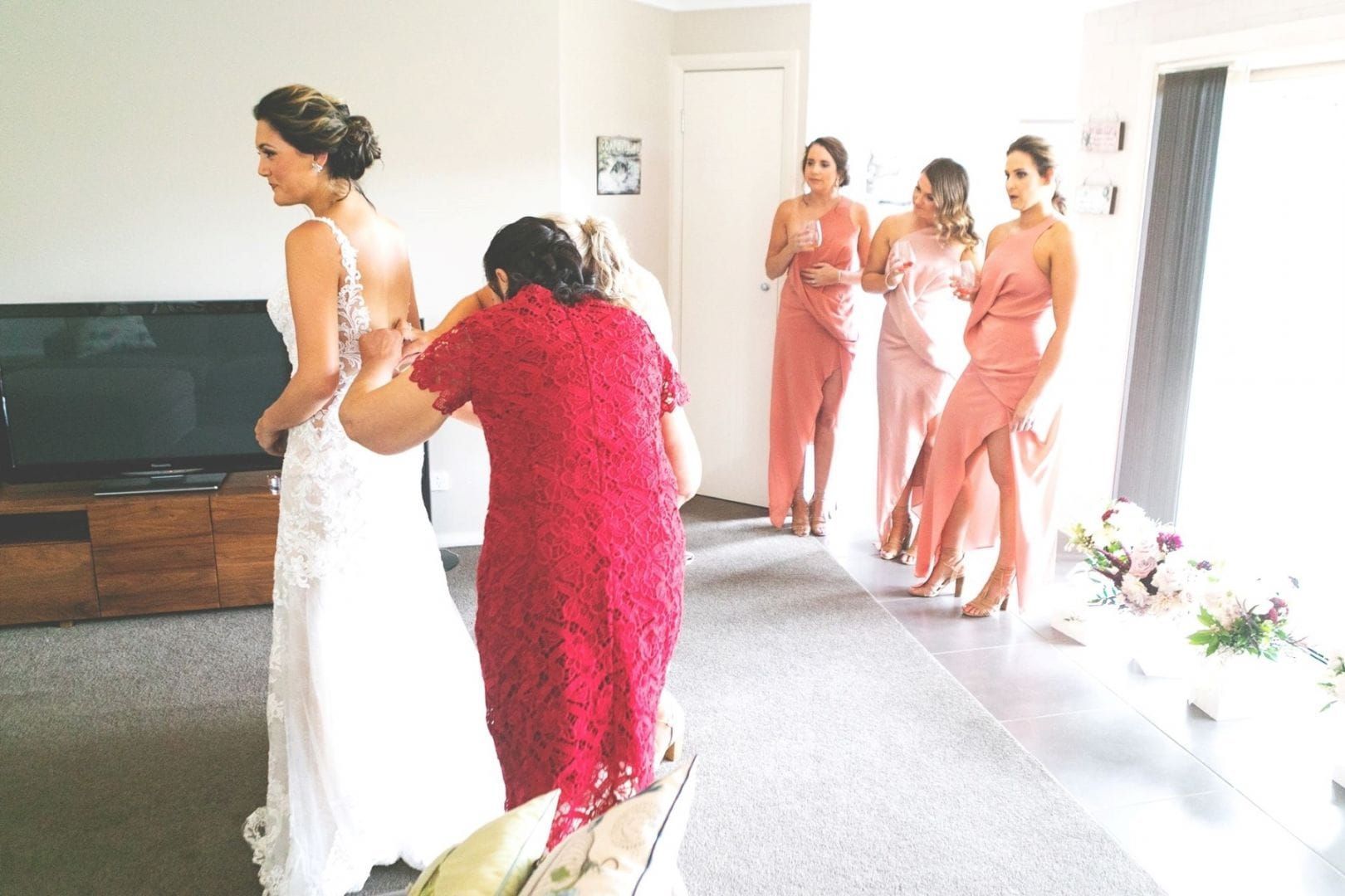 A Woman in a Red Dress Helps a Bride Get Ready for Her Wedding — Lakeview Luxury Retreat in Canobolas, NSW