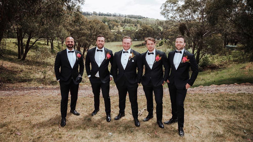 A Group of Men in Tuxedos and Bow Ties Are Standing Next to Each Other in a Field — Lakeview Luxury Retreat in Canobolas, NSW