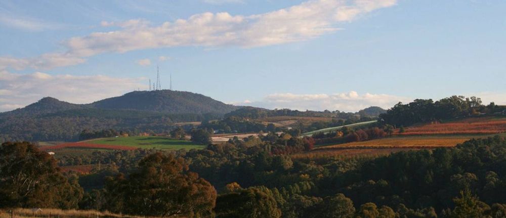 A View of a Valley With Mountains in the Background and Trees in the Foreground — Lakeview Luxury Retreat in Canobolas, NSW