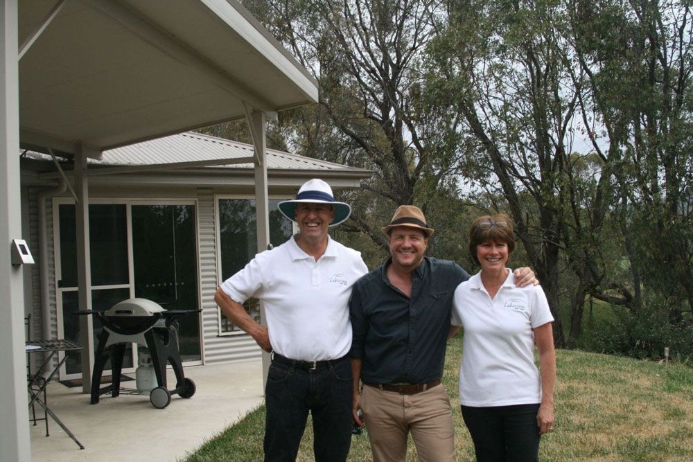 Three People Posing for a Picture in Front of a House — Lakeview Luxury Retreat in Canobolas, NSW