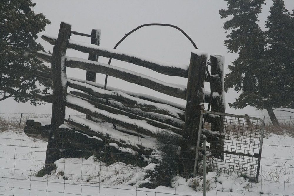 A Black and White Photo of a Fence in the Snow — Lakeview Luxury Retreat in Canobolas, NSW
