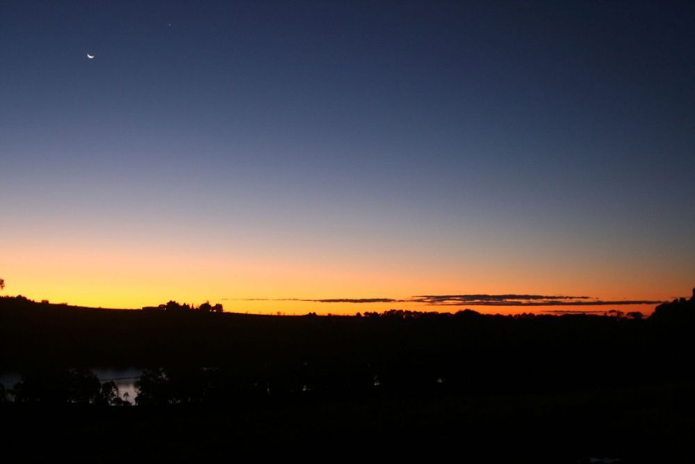 A Sunset Over a Lake With a Moon in the Sky — Lakeview Luxury Retreat in Canobolas, NSW