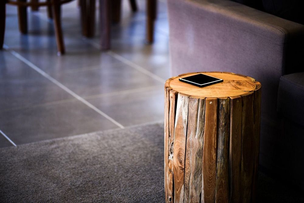 A Wooden Stump With a Cell Phone on Top of It — Lakeview Luxury Retreat in Canobolas, NSW