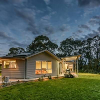 A Small House With a Large Lawn in Front of It — Lakeview Luxury Retreat in Canobolas, NSW