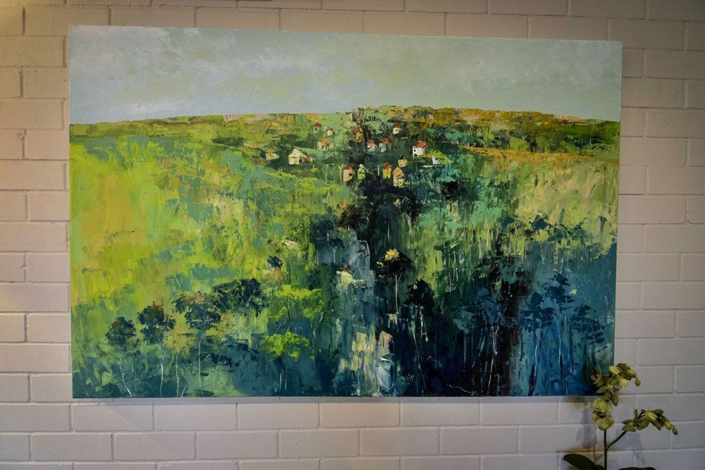 A Large Painting is Hanging on a White Brick Wall — Lakeview Luxury Retreat in Canobolas, NSW