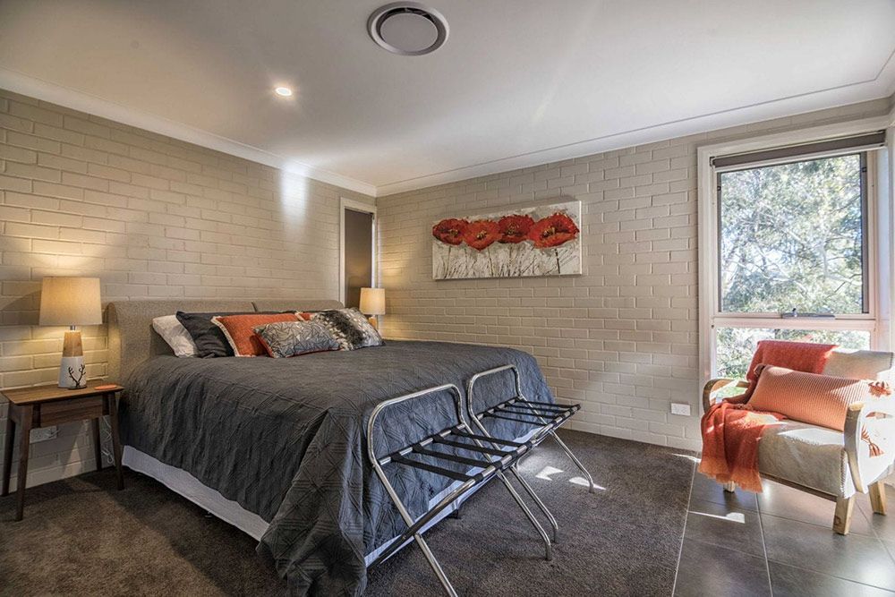 There is a Large Bed in the Middle of the Room — Lakeview Luxury Retreat in Canobolas, NSW