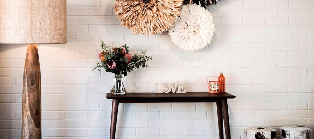 A Wooden Table With a Vase of Flowers on It in a Living Room — Lakeview Luxury Retreat in Canobolas, NSW