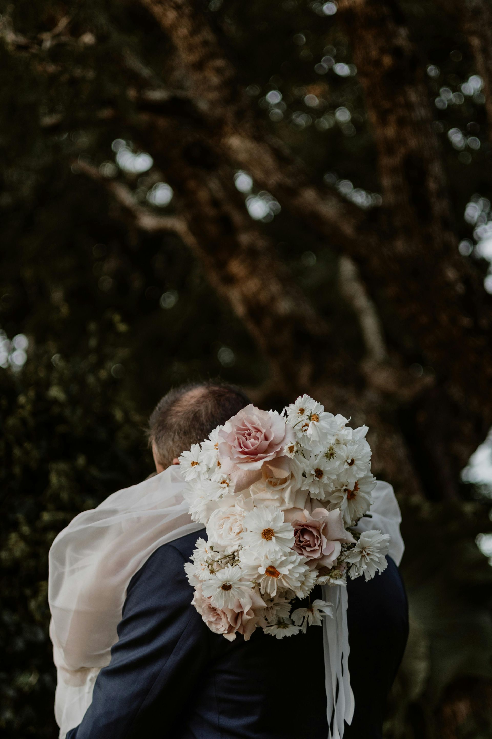A Bride is Sitting on a Wooden Stump Next to Her Wedding Dress — Lakeview Luxury Retreat in Canobolas, NSW