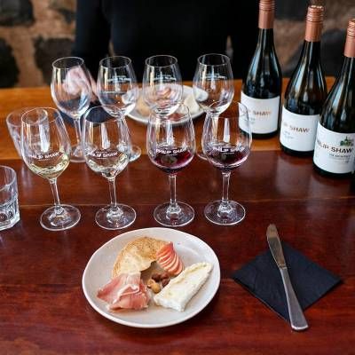 A Table With a Plate of Food and Wine Glasses on It — Lakeview Luxury Retreat in Canobolas, NSW