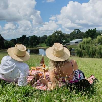 A Man and a Woman Are Having a Picnic in a Field — Lakeview Luxury Retreat in Canobolas, NSW