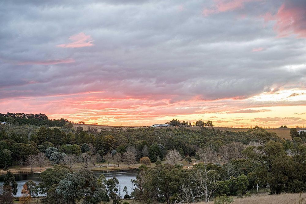 Sunset Over Lake With Trees and Cloudy Sky — Lakeview Luxury Retreat in Canobolas, NSW