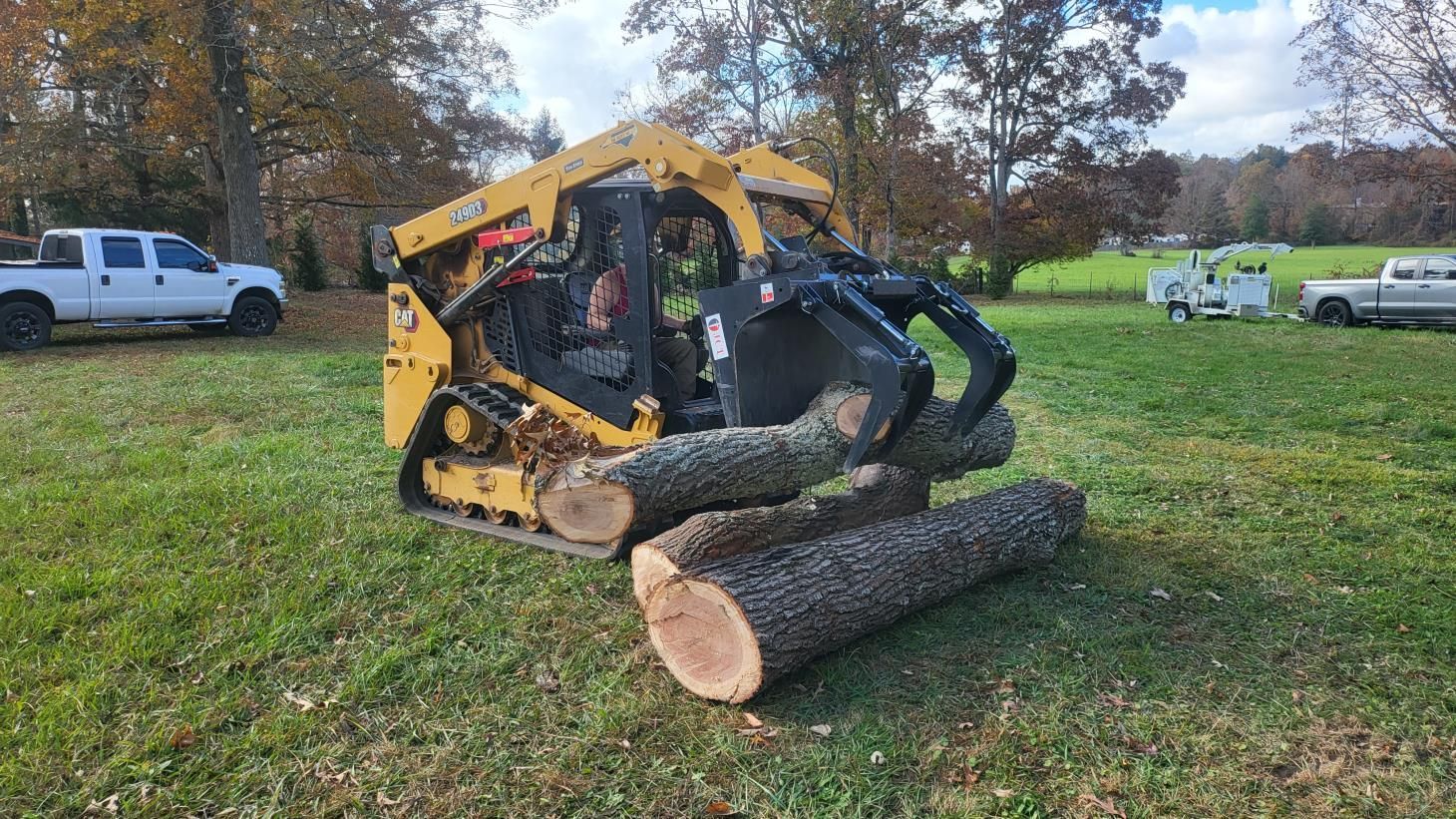 Stump grinder in action, removing a tree stump and turning it into wood chips.