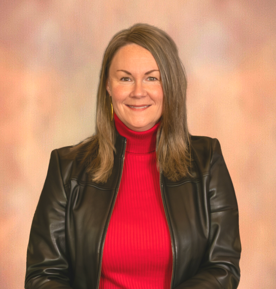Woman with blonde hair in red blazer smiles at camera.