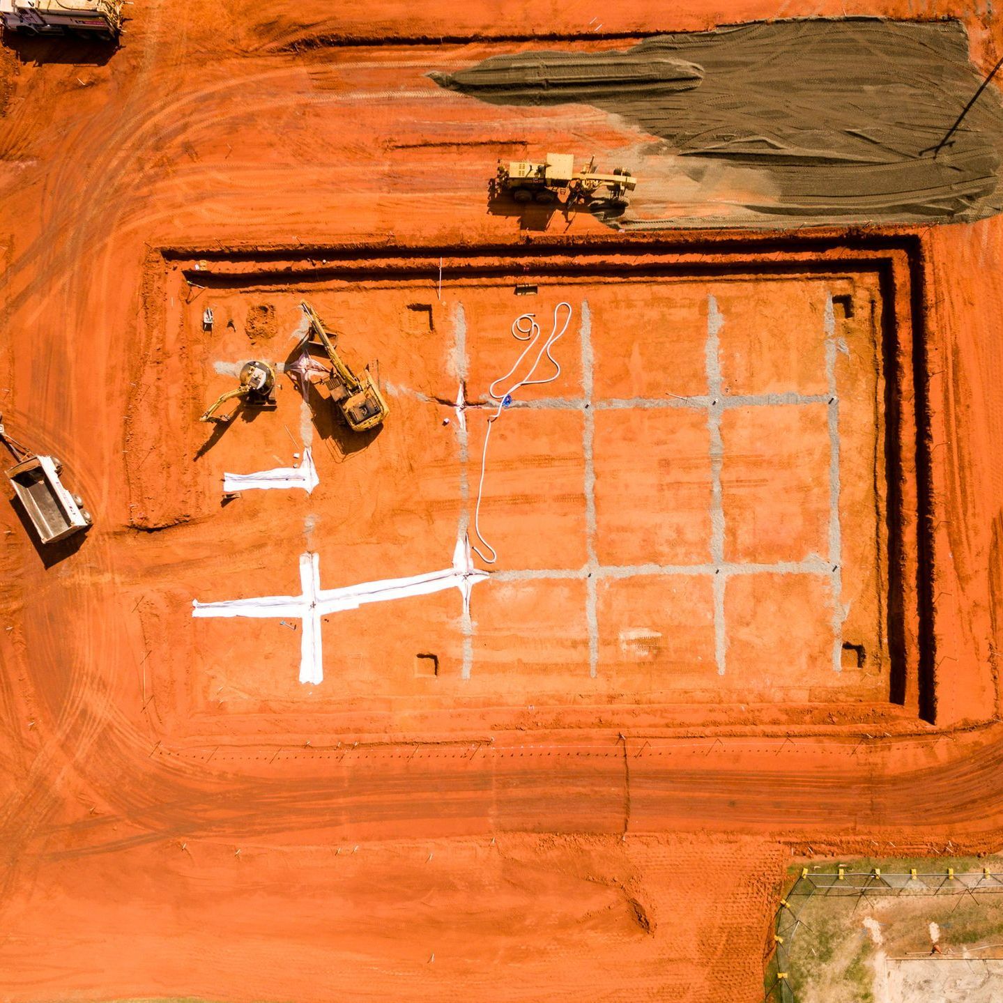 Aerial view of a construction site with a gridded foundation. Aerial view of a construction site with a gridded foundation.