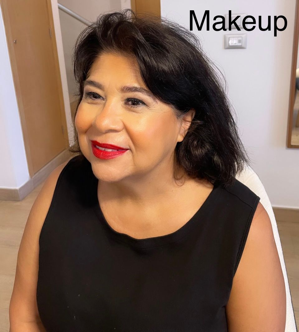 A woman wearing red lipstick and a black shirt is smiling.