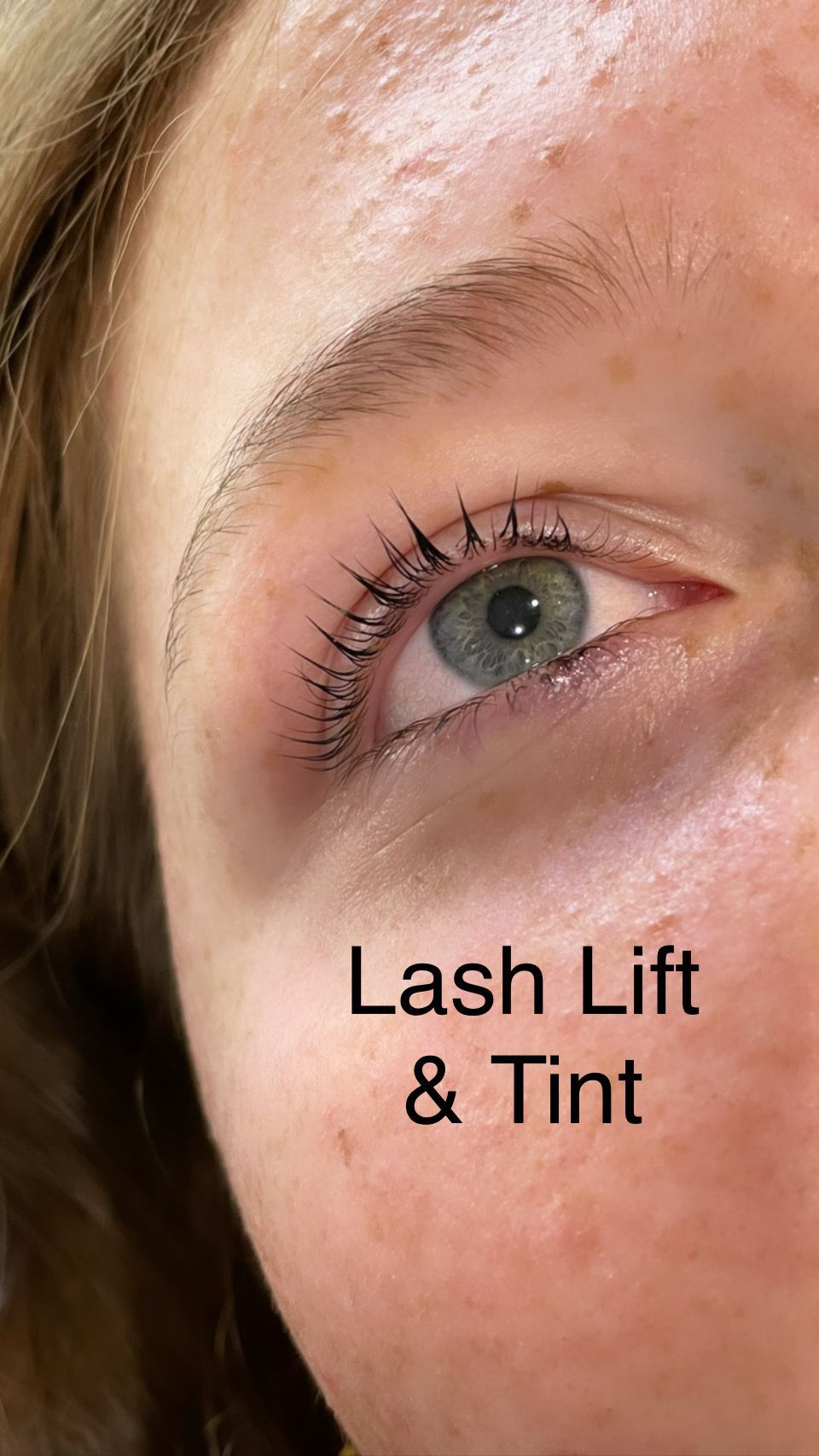 A close up of a woman 's eye with lash lift and tint.