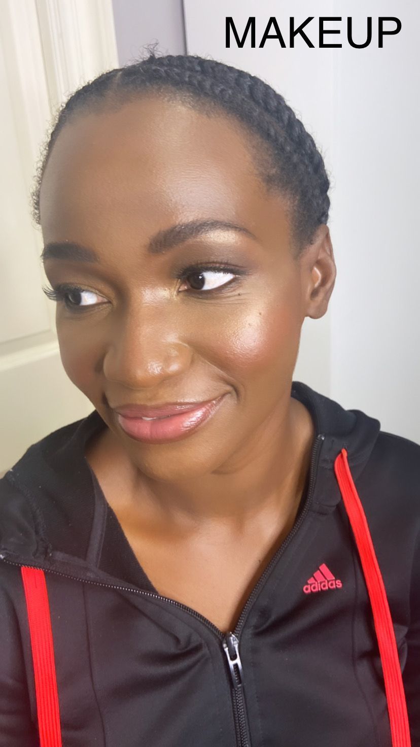 A woman wearing a black adidas hoodie has makeup on her face.
