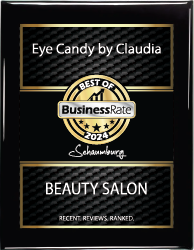 A black and gold plaque for eye candy by claudia beauty salon.