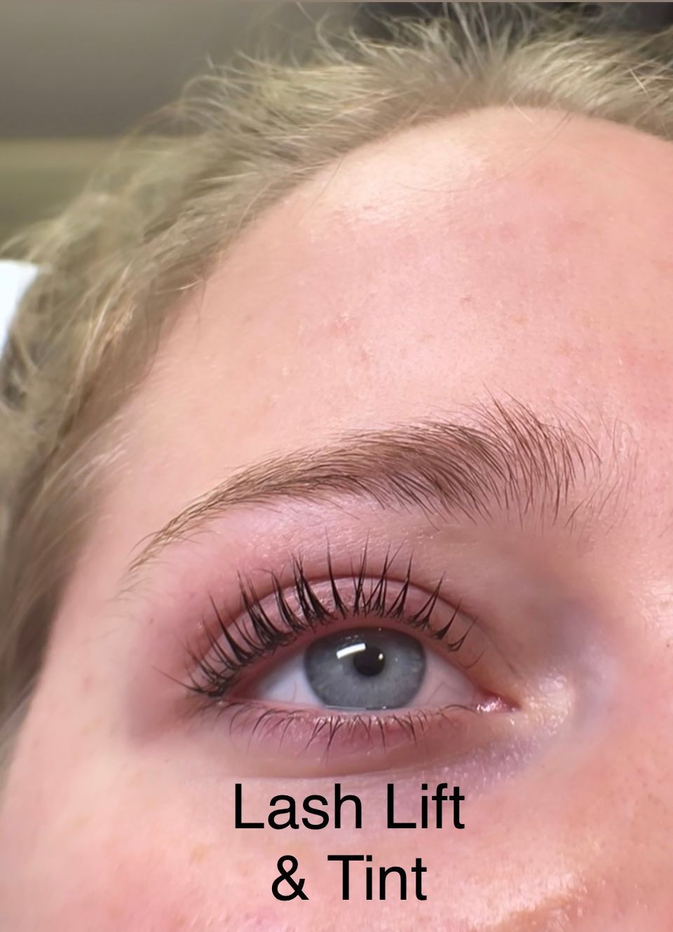 A close up of a woman 's eye with lash lift and tint.