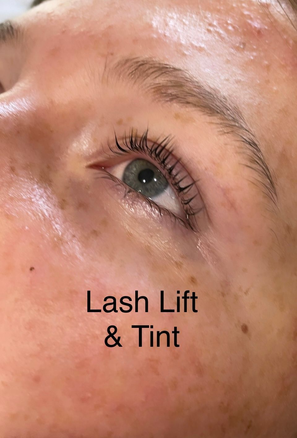A close up of a woman 's eye with lash lift and tint.