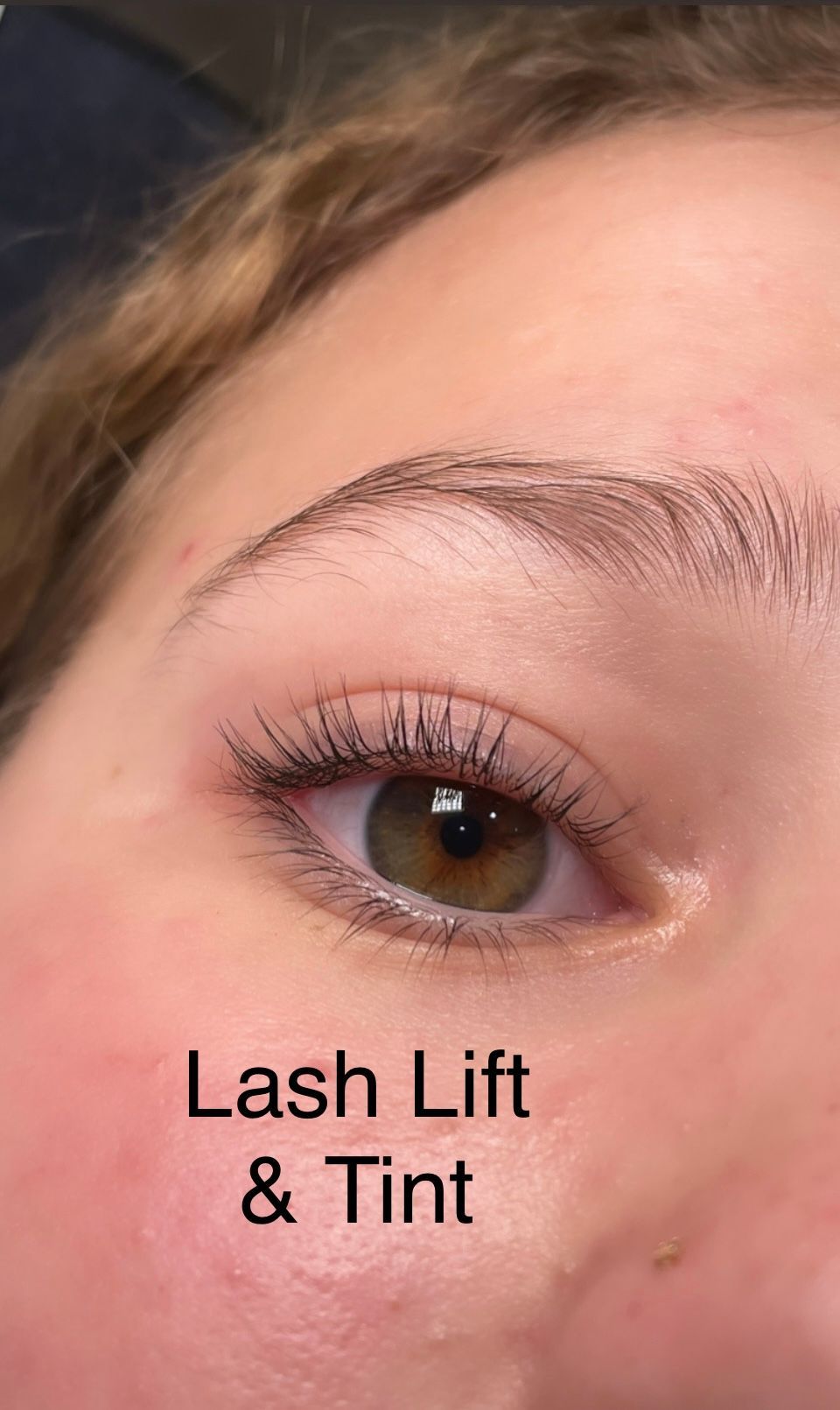 A close up of a woman 's eye with lash lift and tint.