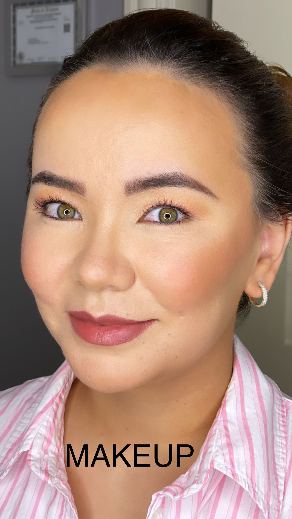 A close up of a woman 's face with the word makeup on her neck.