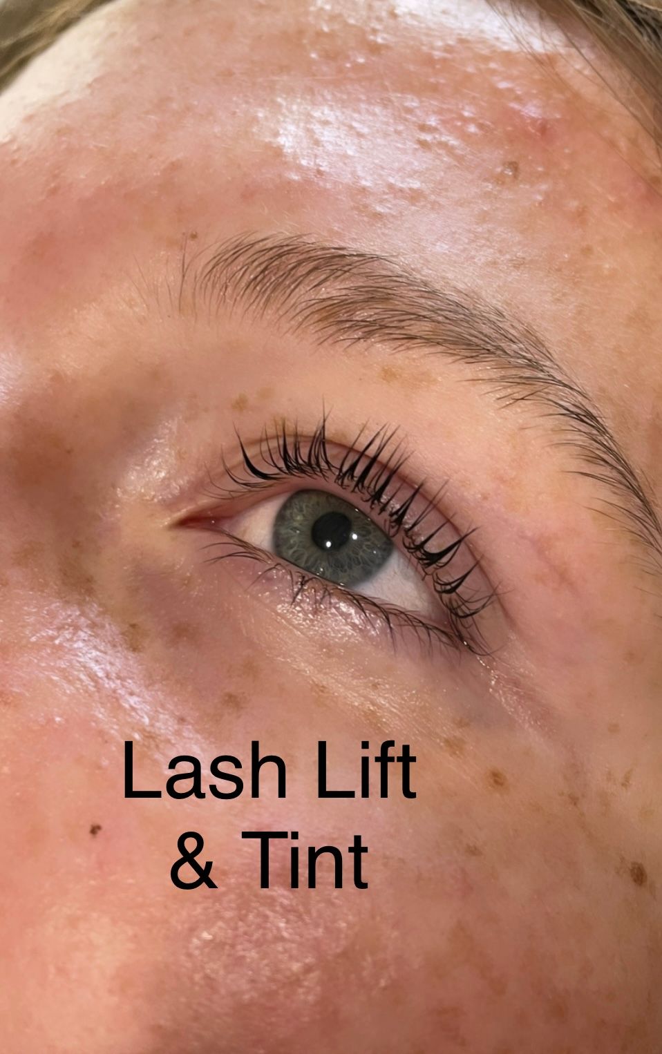 A close up of a woman 's eye with a lash lift and tint.