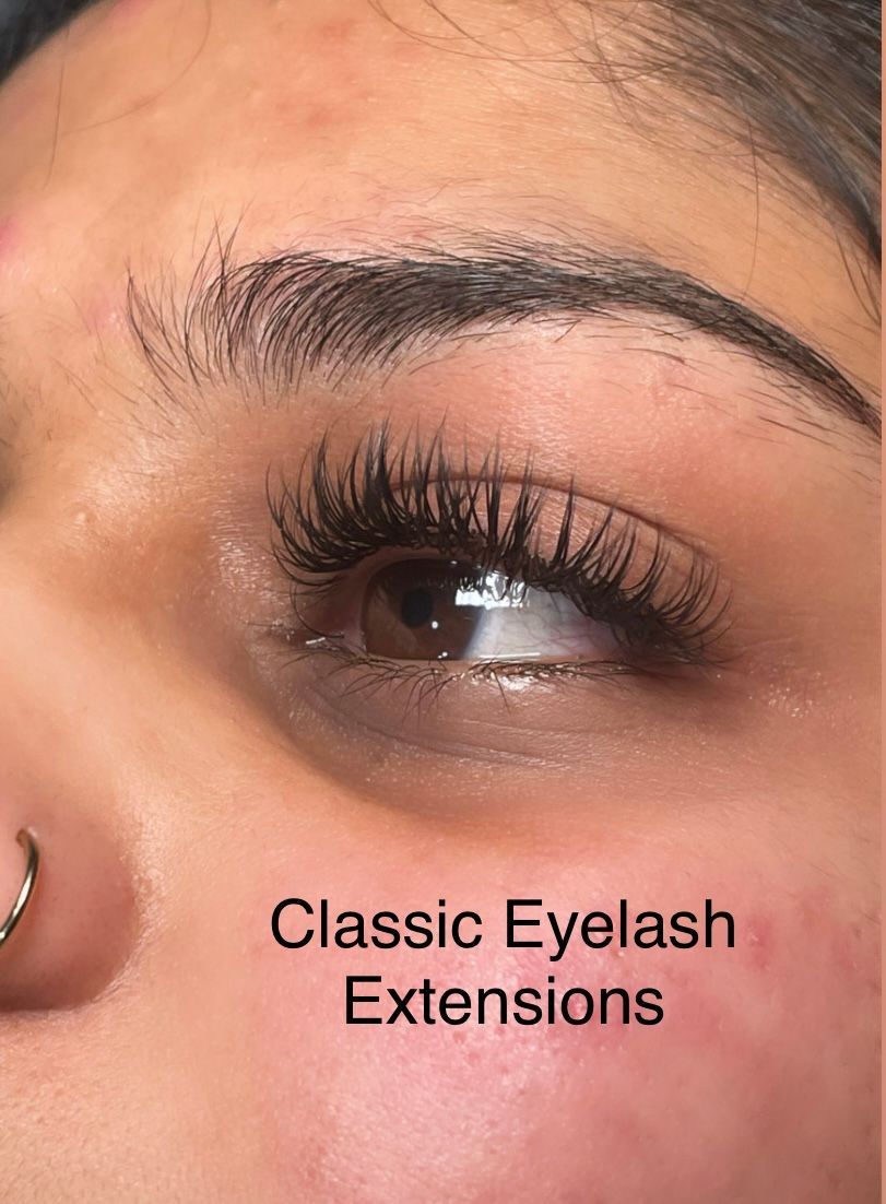 A close up of a woman 's eye with classic eyelash extensions.