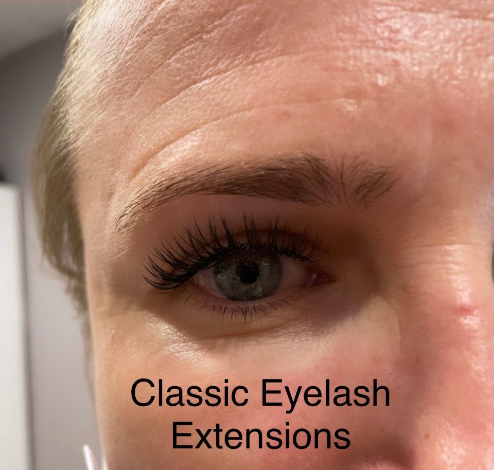 A close up of a woman 's eye with classic eyelash extensions