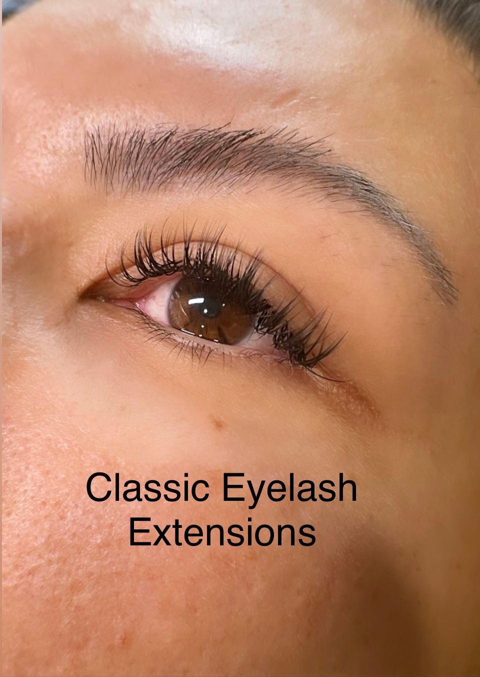 A close up of a woman 's eye with classic eyelash extensions.