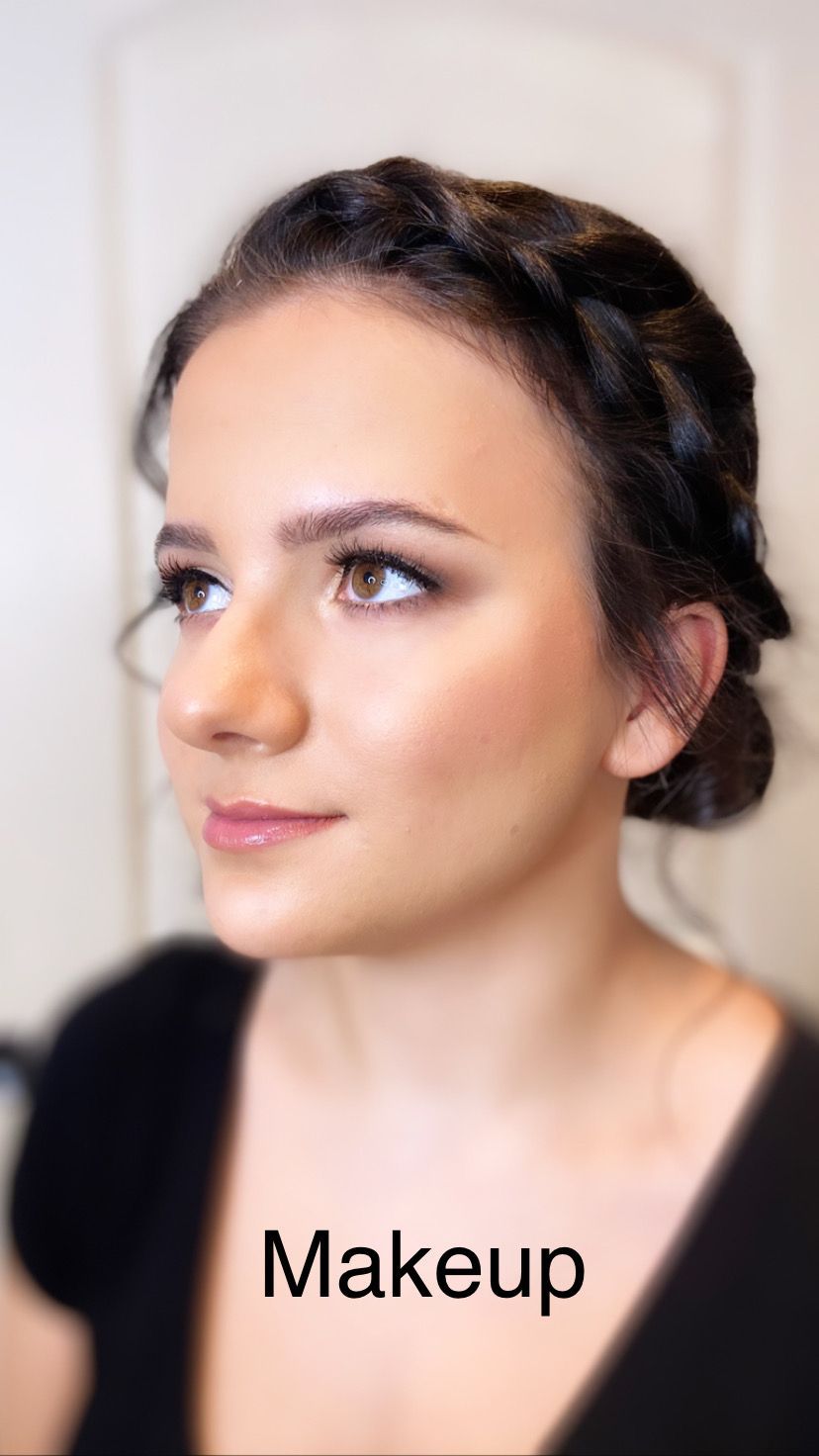 A woman is wearing a braided headband and a black shirt.