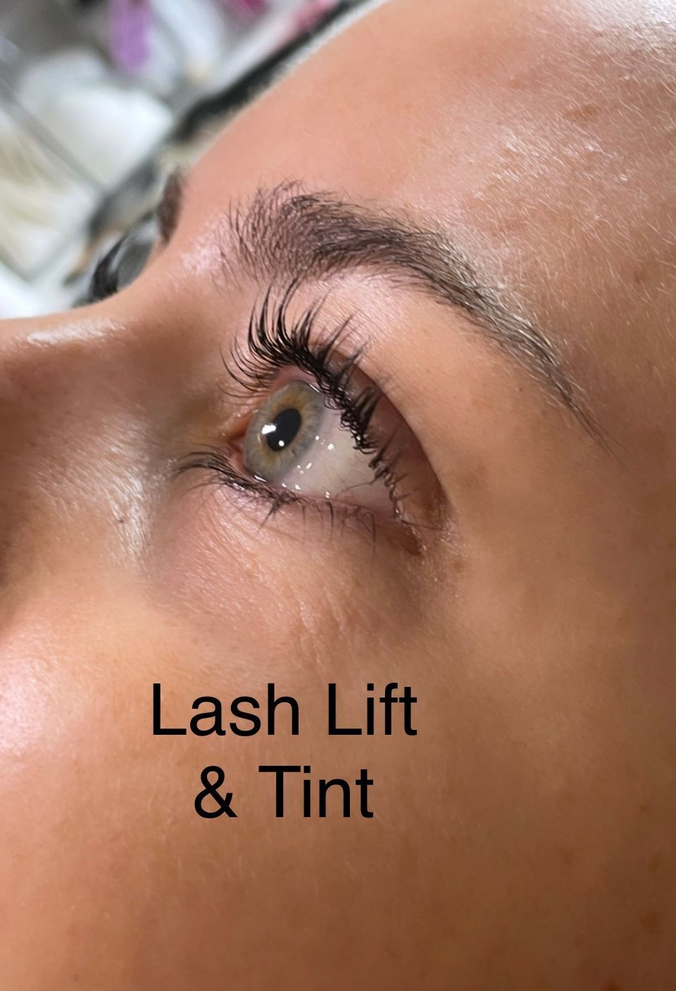 A close up of a woman 's eye with lash lift and tint