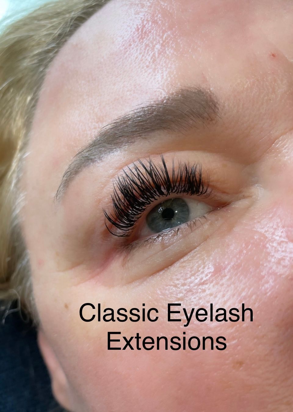 A close up of a woman 's eye with classic eyelash extensions.