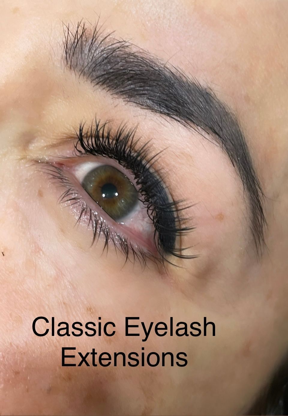 A close up of a woman 's eye with classic eyelash extensions.