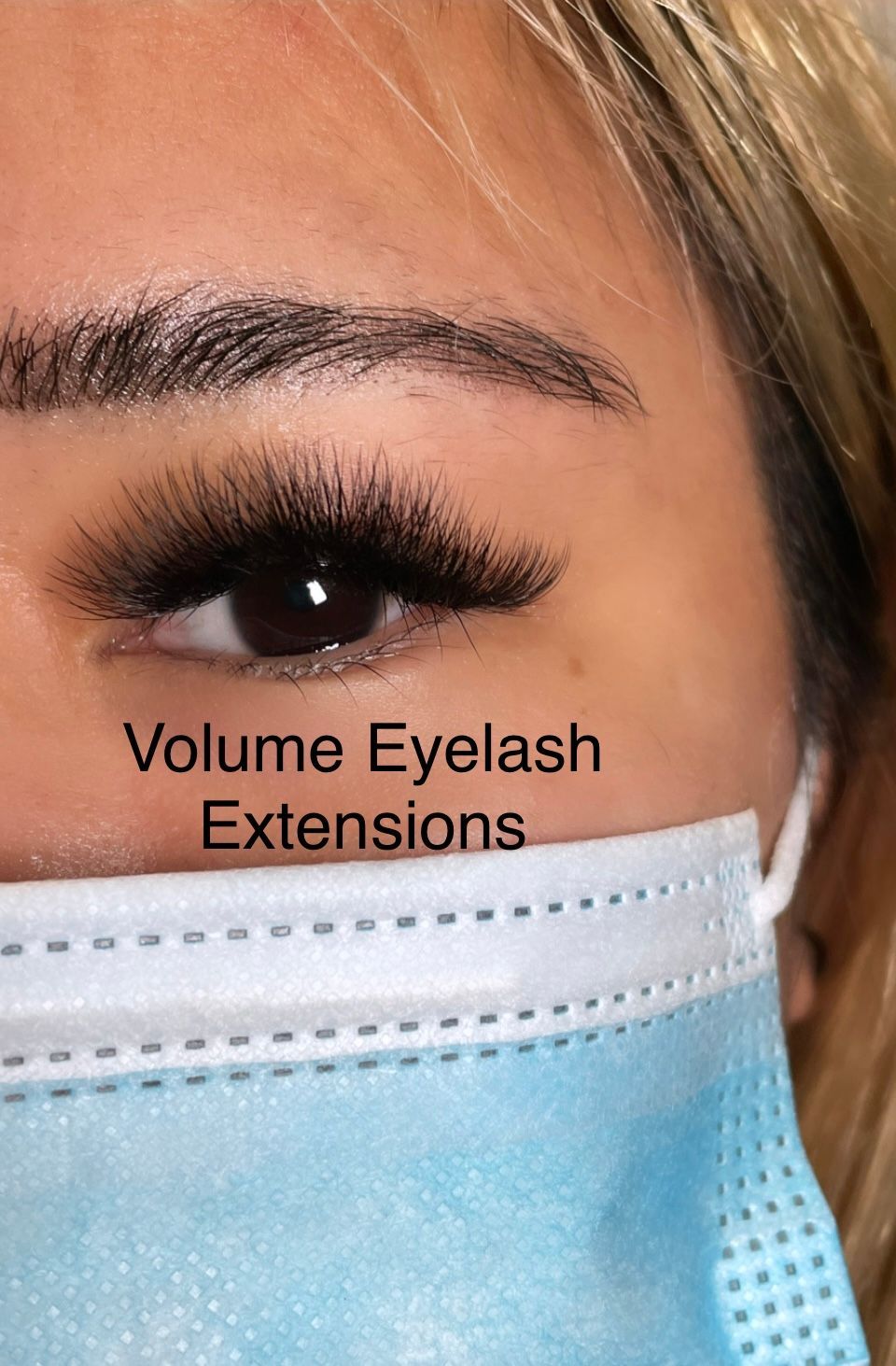 A close up of a woman 's eye with a mask on.