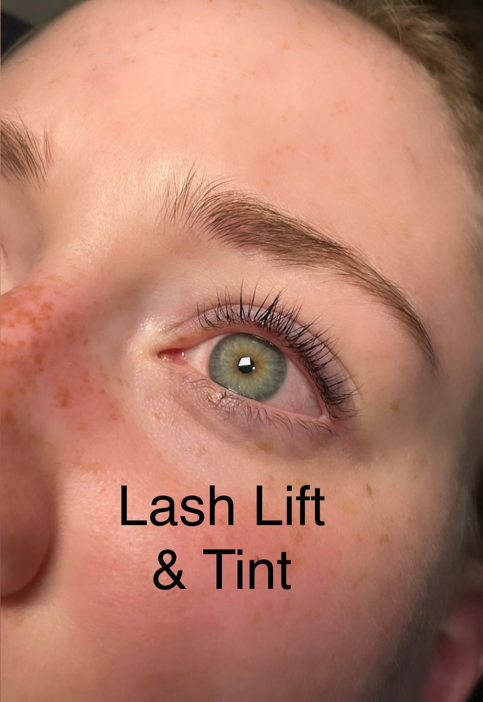 A close up of a woman 's eye with the words lash lift and tint below it