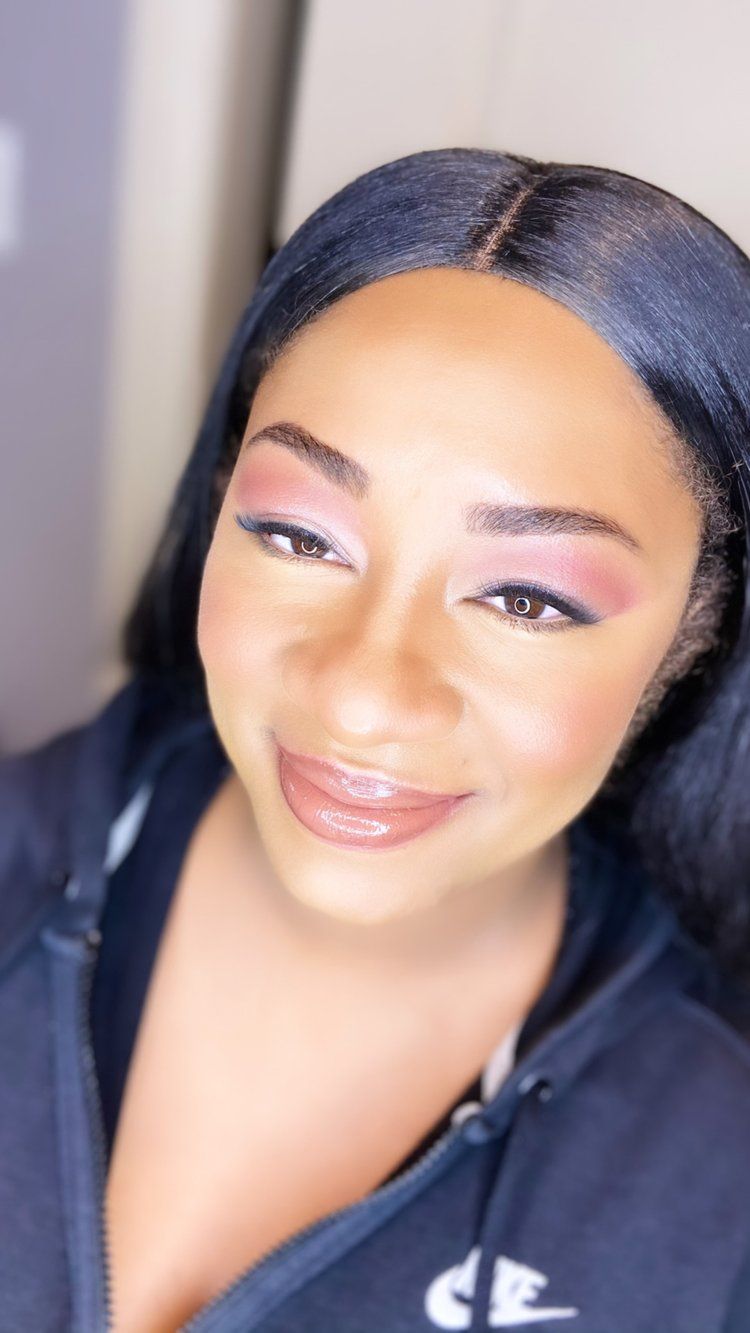 A woman wearing a blue sweatshirt with the letter c on it