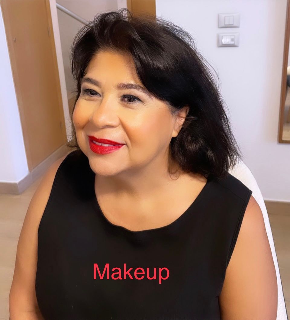A woman wearing a black shirt that says makeup on it