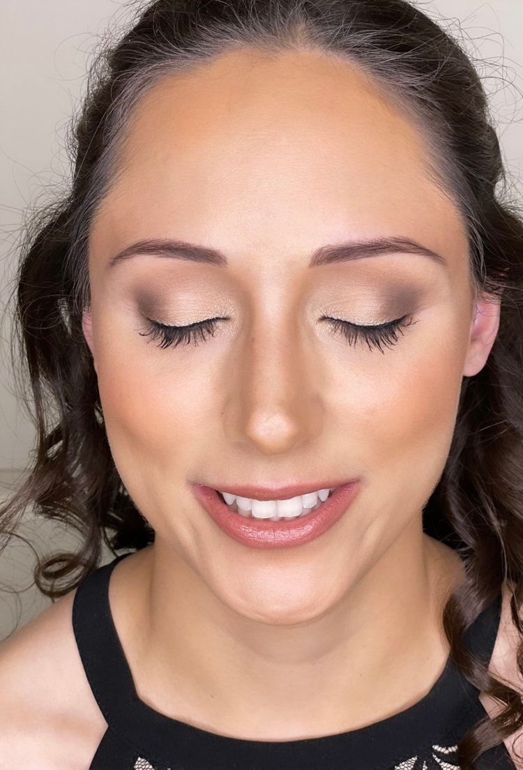 A close up of a woman 's face with her eyes closed