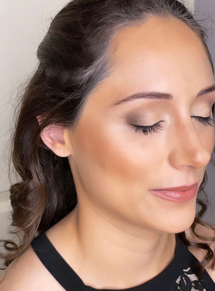 A close up of a woman 's face with her eyes closed.