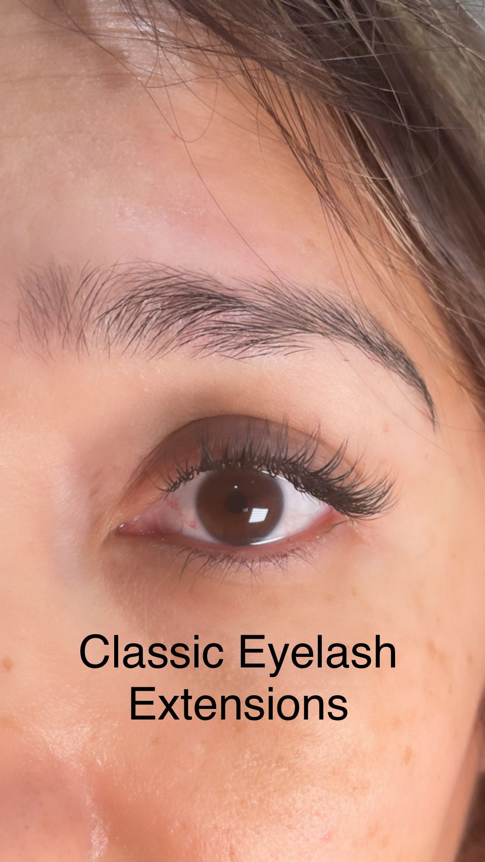 A close up of a woman 's eye with classic eyelash extensions