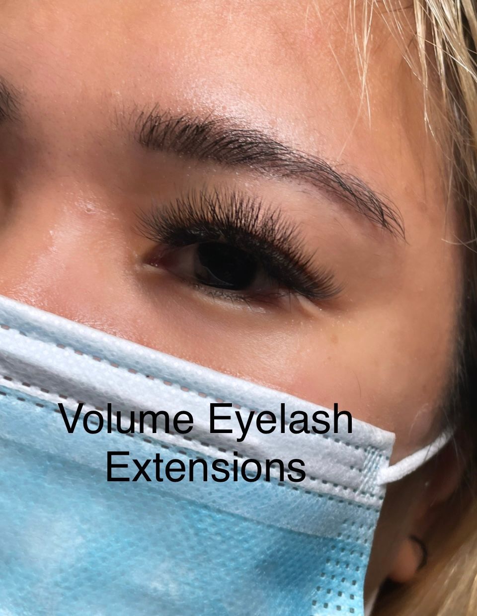 A close up of a woman wearing a mask with eyelash extensions.
