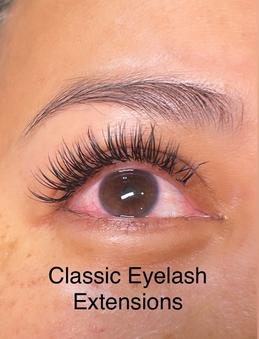 A close up of a woman 's eye with classic eyelash extensions.