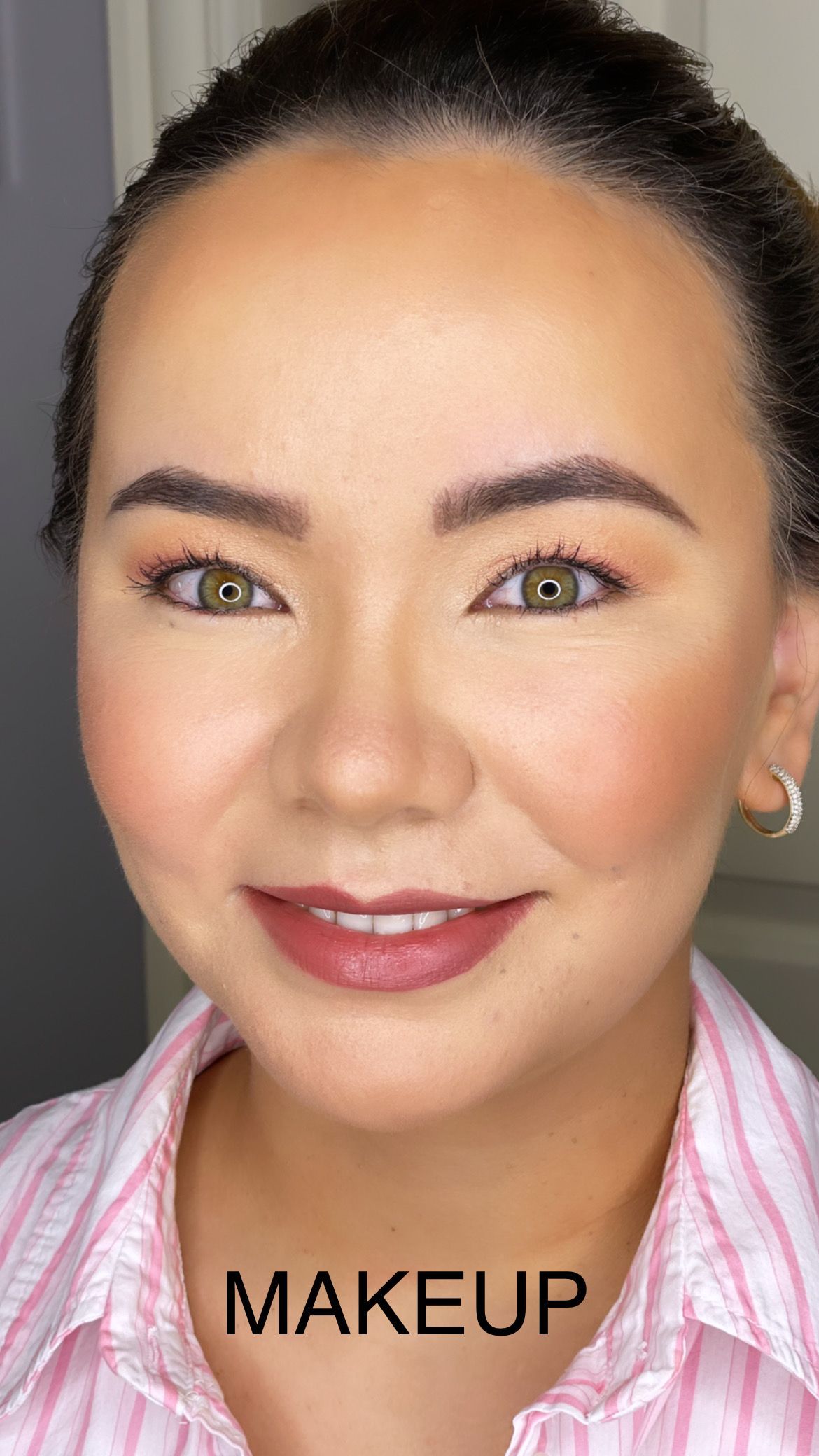 A close up of a woman 's face with makeup on.