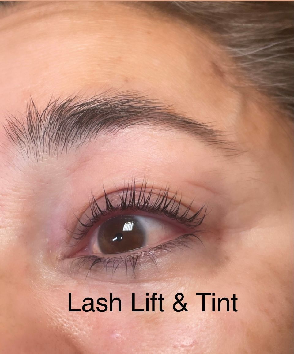 A close up of a woman 's eye with lash lift and tint.