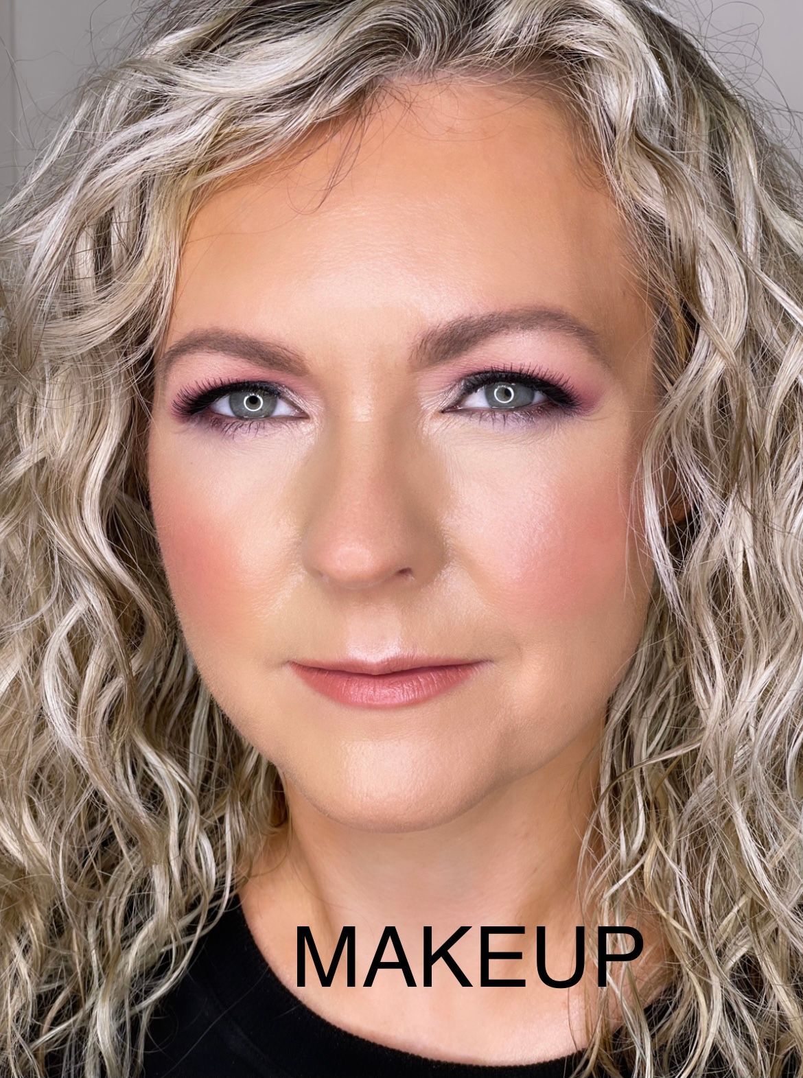 A close up of a woman 's face with makeup on.