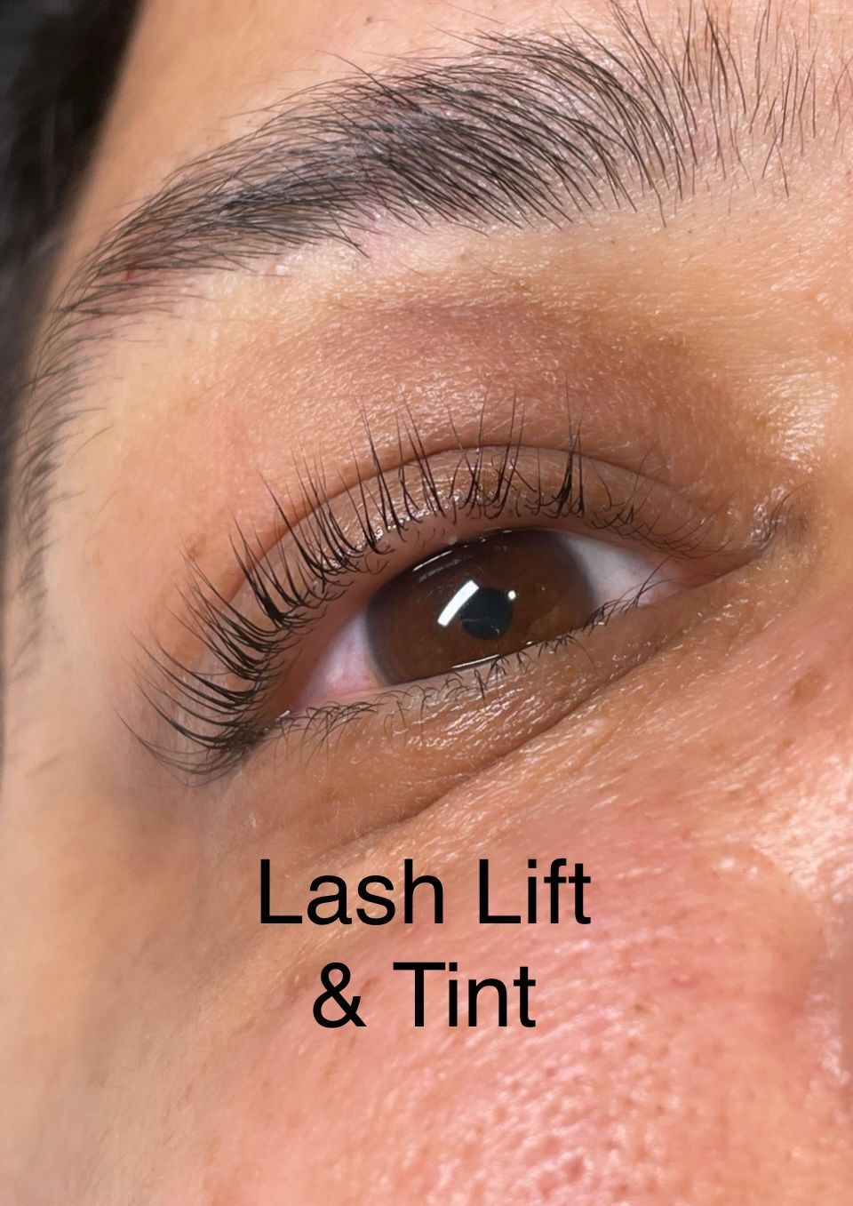 A close up of a woman 's eye with lash lift and tint.